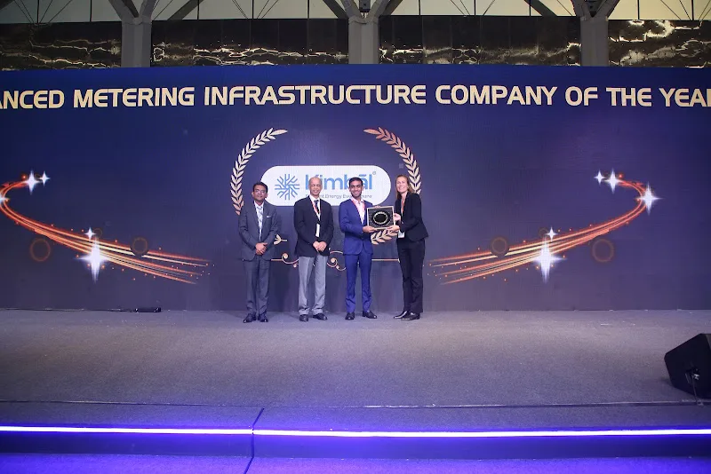 Award presentation against the ceremony?s metering infrastructure backdrop