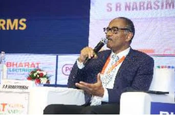 A seated speaker in a dark jacket addressing the Day 1 audience