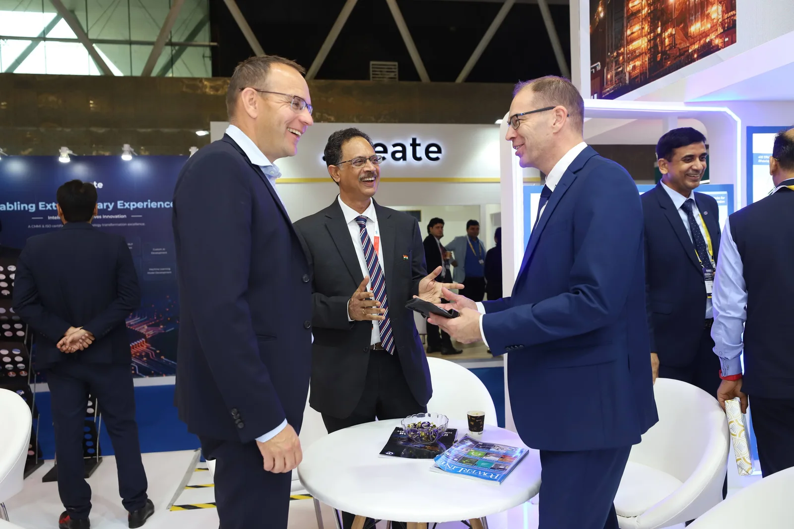 Energy industry professionals speaking together at an exhibition stand
