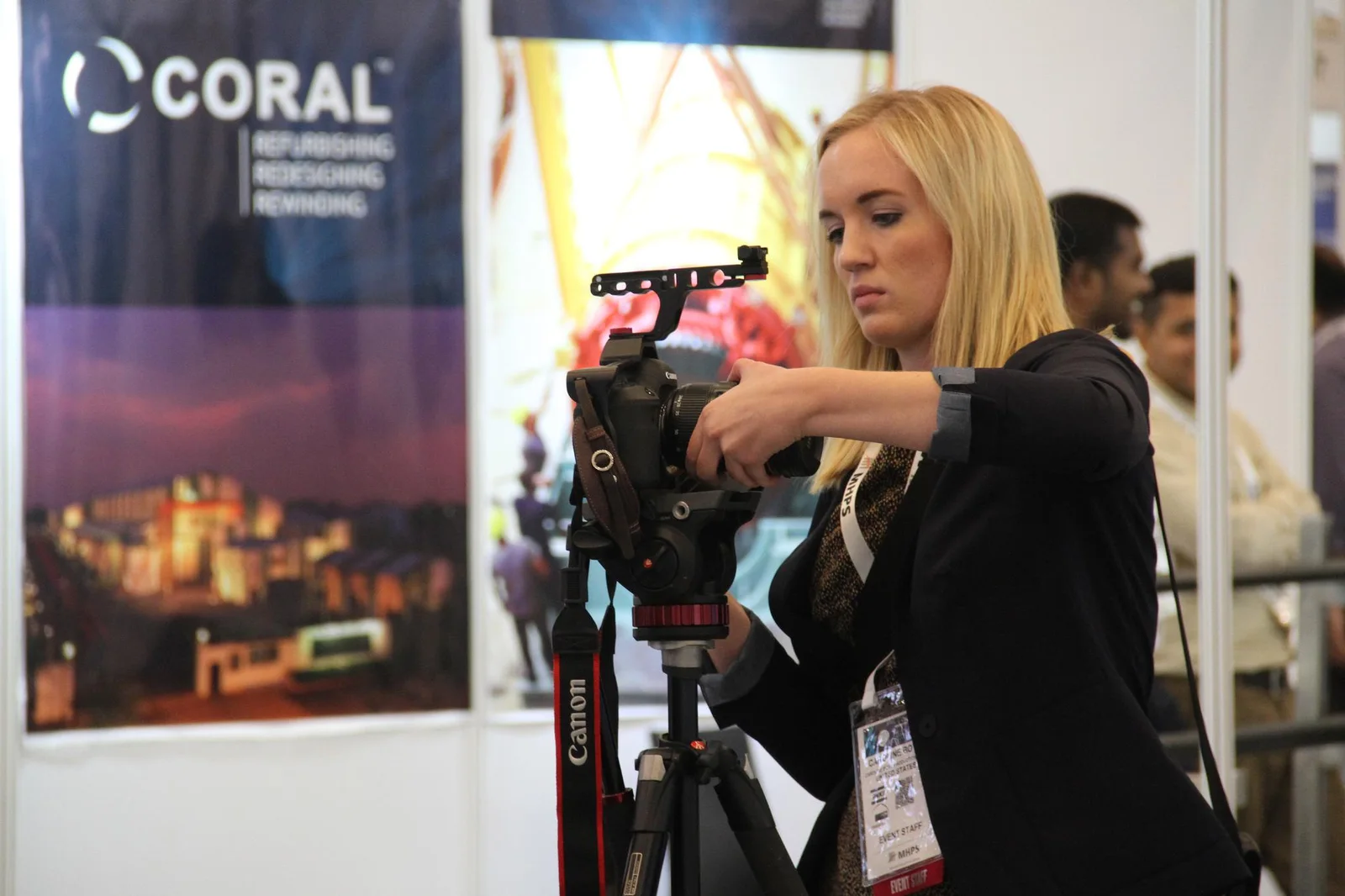 A media professional filming at an energy exhibition